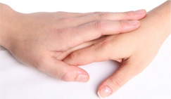 image of one person's hand gently holding another